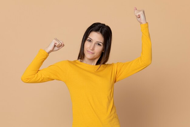 Attractive young girl wearing a yellow T-shirt