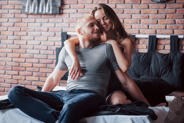 Photo attractive young lovers have a couple playing together in bed.