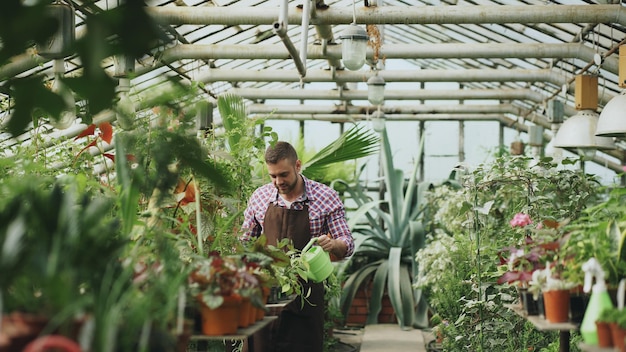 Attractive young man enjoy his job in garden