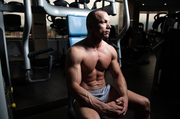 Attractive Young Man Resting In Gym Afther Exercise