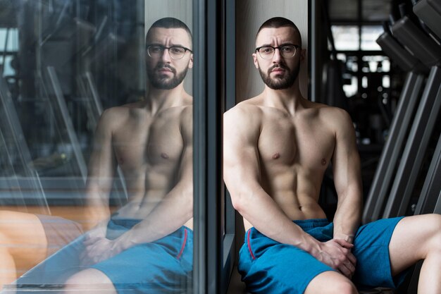 Attractive Young Man Resting In Gym Afther Exercise