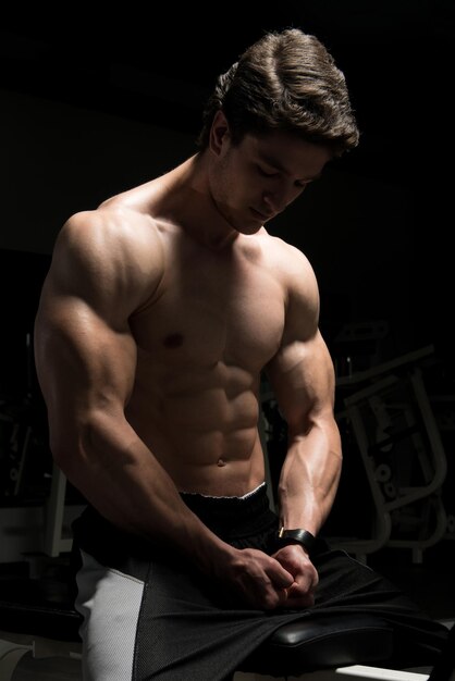 Attractive Young Man Resting In Gym Afther Exercise