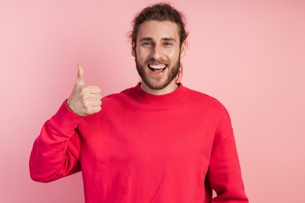 Attractive, young man shows his thumb up, he is happy sincerely. Guy  .