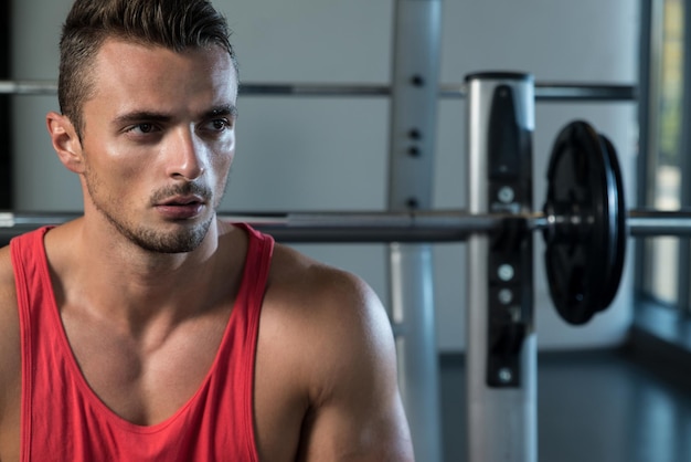 attractive young man sitting on bench
