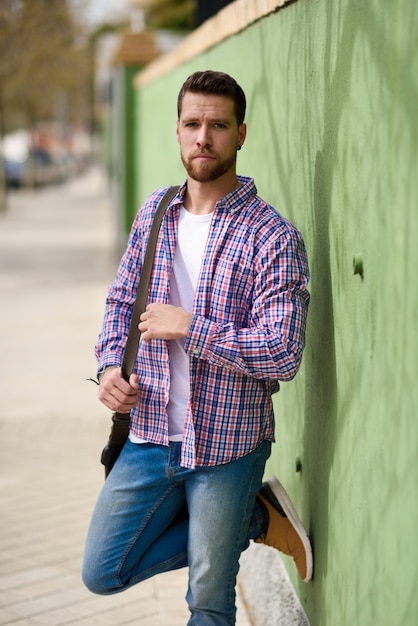 Photo attractive young man standing in urban background. lifestyle concept.