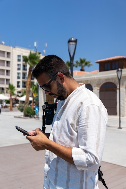 Привлекательный молодой человек с помощью мобильного телефона на улице