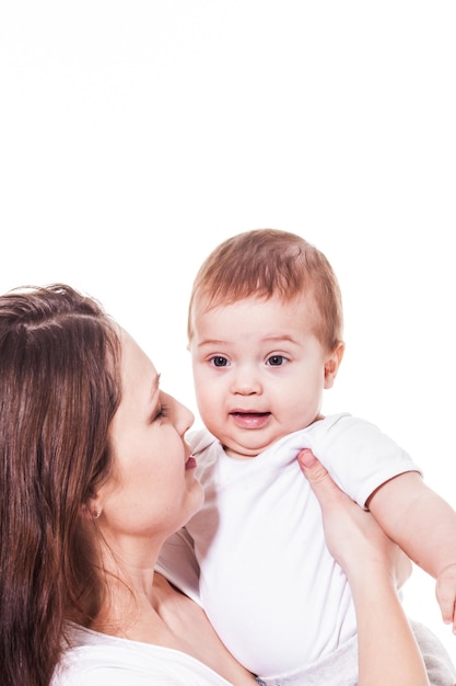 Attractive young mother looking at her wondering blue-eyed baby