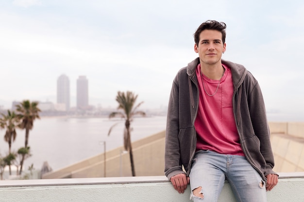 Attractive young student sitting in front of city