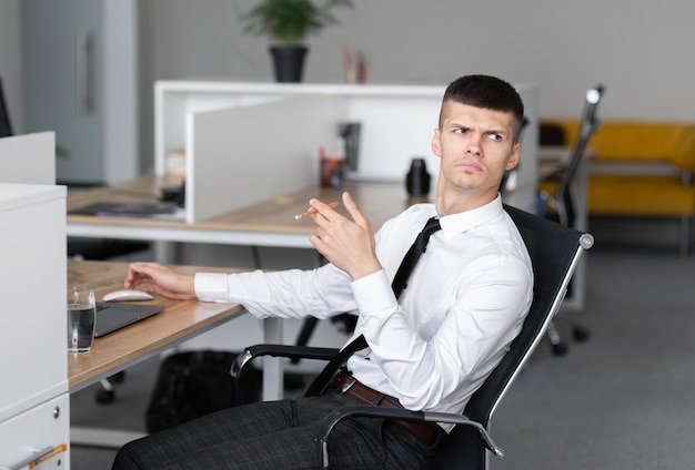 Attractive young surprised man in the office at work