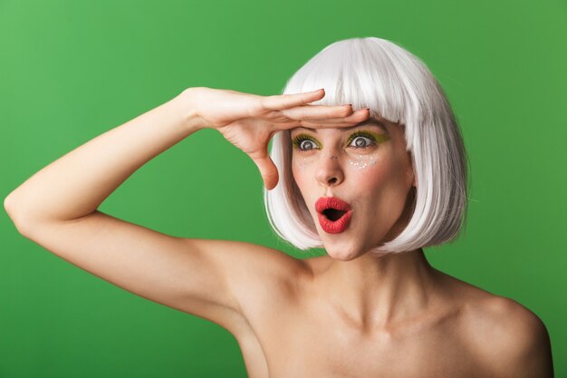 Attractive young topless woman wearing short white hair standing isolated, looking far away