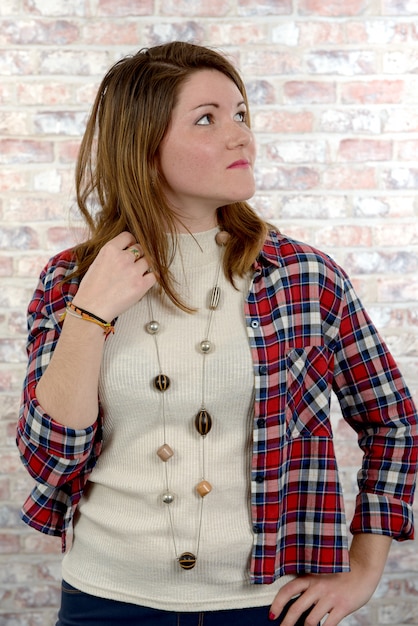 Attractive young woman in a checkered shirt