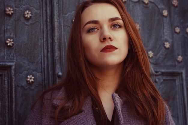 Attractive young woman at the door. Closeup shot