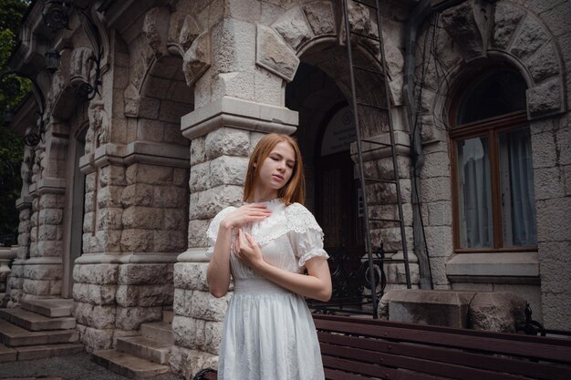 Attractive young woman enjoying her time outside in park Beautiful palace juicy greens after a rain in the spring