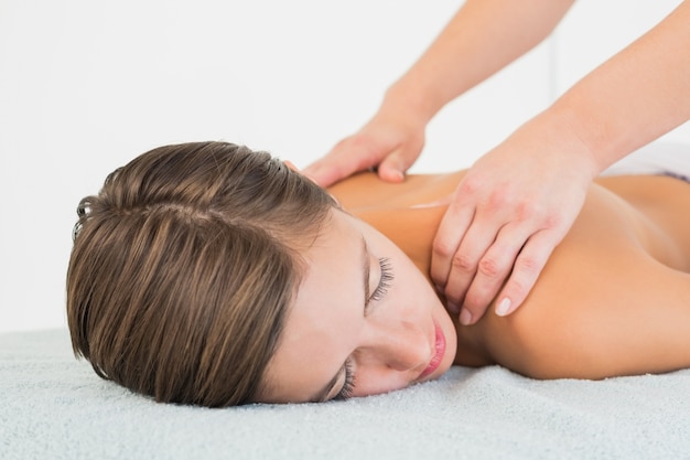 Attractive young woman receiving shoulder massage