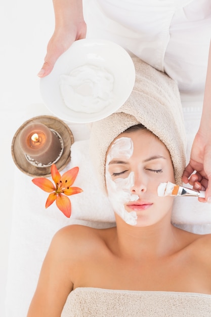 attractive young woman receiving treatment at spa center