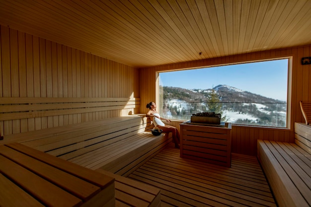 Attractive young woman relaxing in the sauna