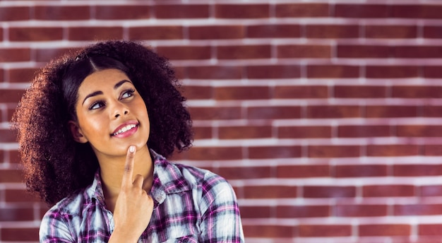 Attractive young woman smiling and daydreaming