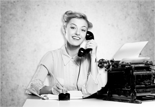 Attractive young woman speaking on  vintage phone