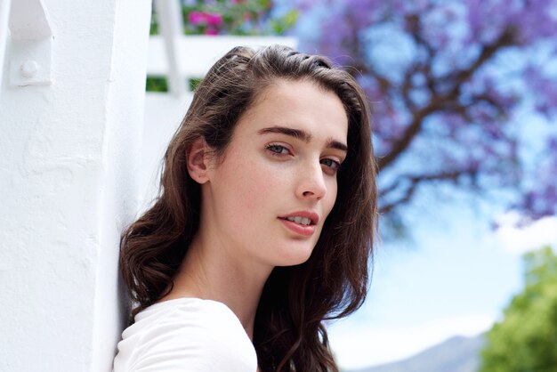 Attractive young woman standing outdoors in spring