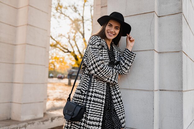 Attractive young woman walking in autumn wearing coat