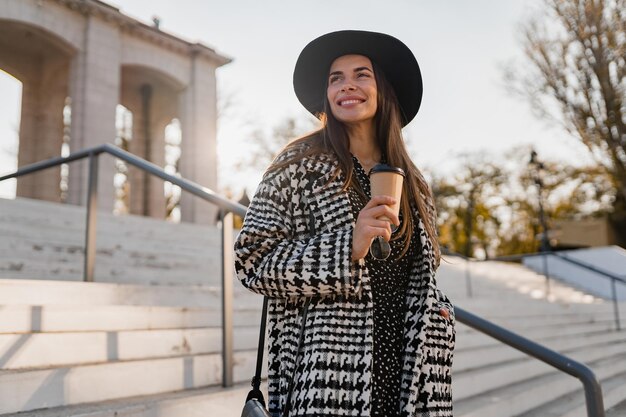 Attractive young woman walking in autumn wearing coat