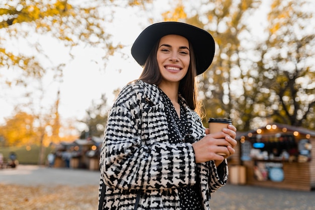 Attractive young woman walking in autumn wearing coat