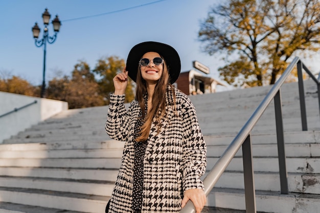 Attractive young woman walking in autumn wearing coat