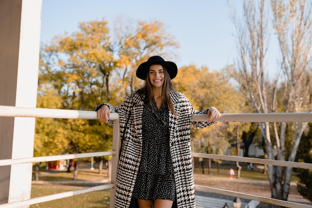 Attractive young woman walking in autumn wearing coat