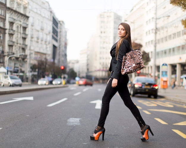 Attractive young woman walking on a street