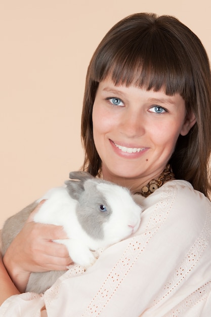 Attractive young woman with a beautiful rabbit 