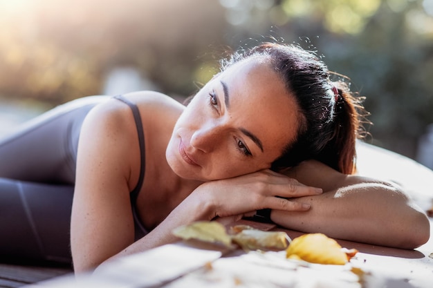 An attractive young woman with a sad pensive expression in a park on a sunny day Shallow depth of field female creative portrait