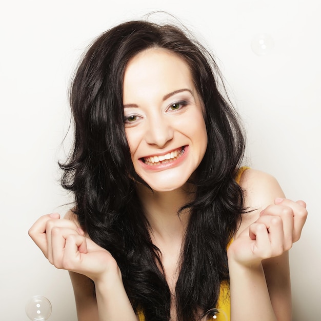 Attractive young woman with soap bubbles