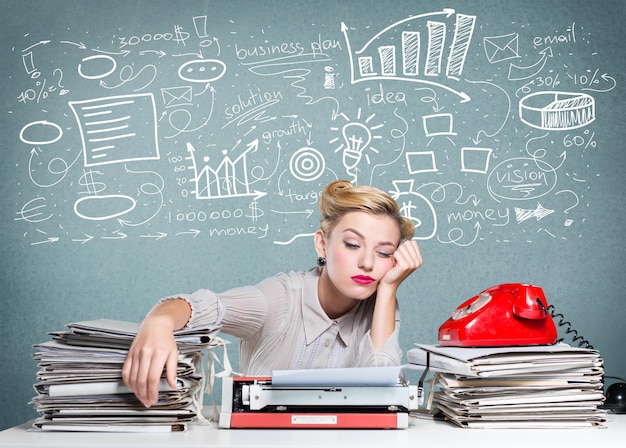 Attractive young woman working on vintage typewriter