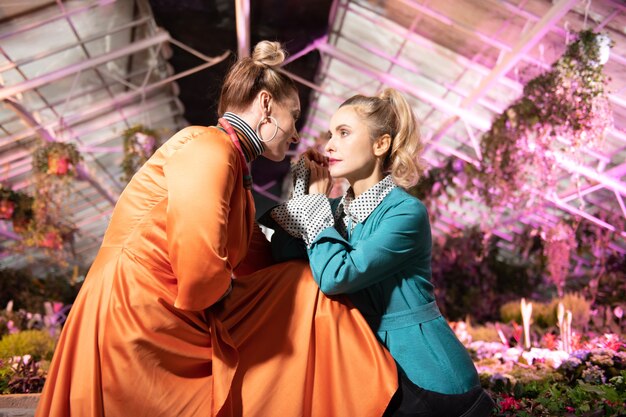 Attractive young women being in the greenhouse