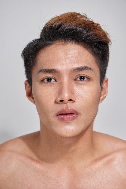 Attractive youthful naked male is expressing confidence