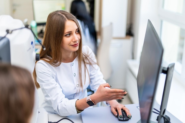 Attrractive professional female doctor explains health care issues to the patient Selective focus