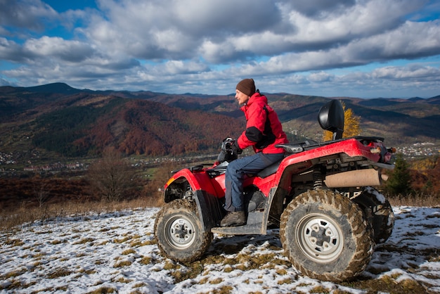 ATV quad bike with driver at the snowy slope