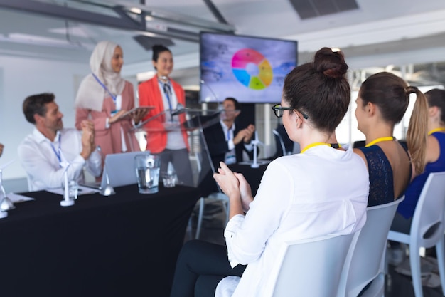 audience applauding while speaker speaks in a business seminar