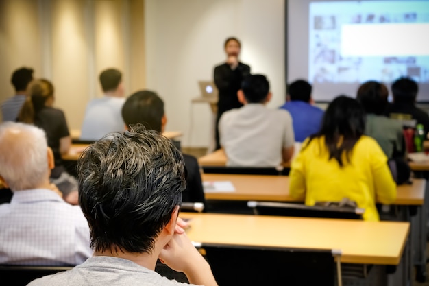 Audience listening speaker who standing in front of the room