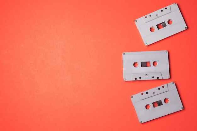 Audio cassette tapes on a orange background. Free space for text