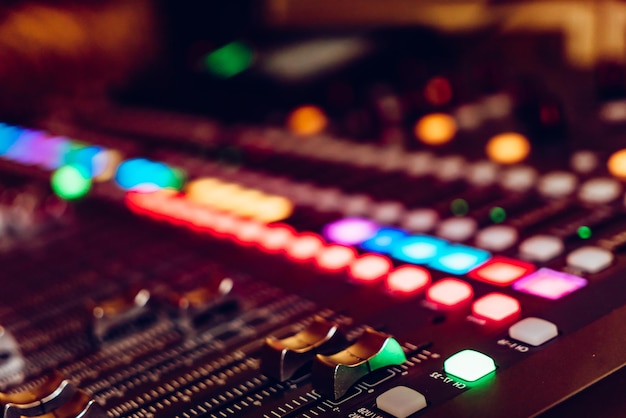 The audio equipment control panel of digital studio mixer side view Closeup selected focus