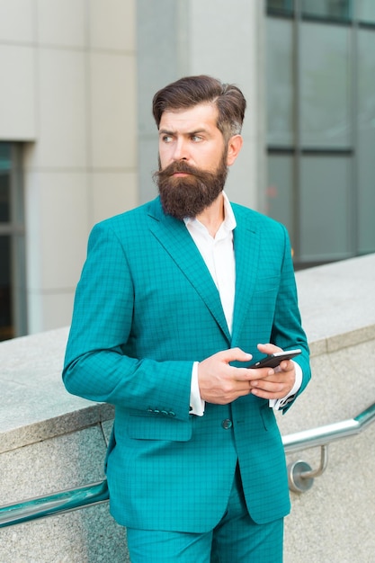 Audio message service. Text messaging. Mobile communication. Email message. Talent of managing. Online business. Bearded man with smartphone. Businessman send sms using smartphone. Send message.