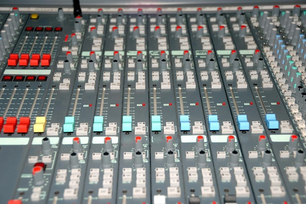 Audio mixing console in a recording studio. Faders and knobs of a sound mixer.