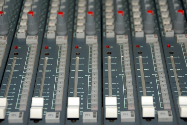 Photo audio mixing console in a recording studio faders and knobs of a sound mixer