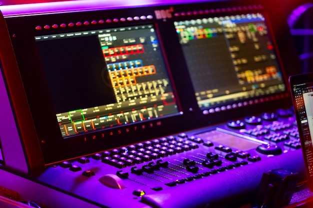 Audio sound mixer console with buttons, sliders and displays at the concert.