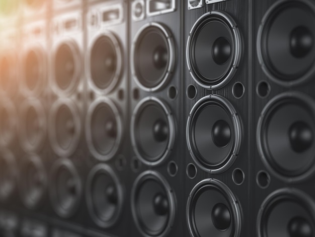Foto audio speaker systeem zwarte luidsprekers in een rij met dof-effect muziekclub achtergrond