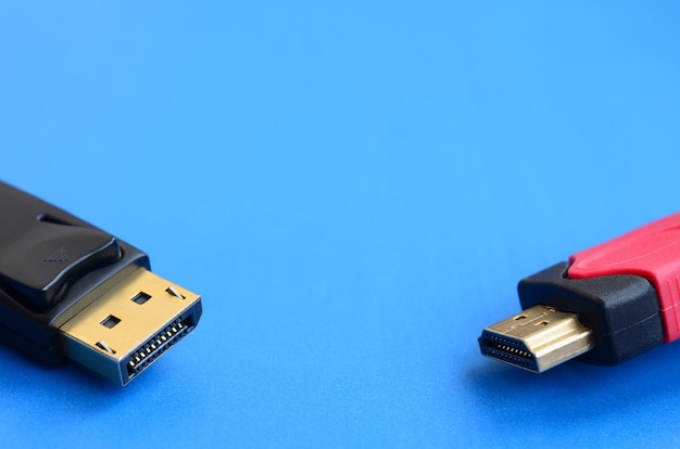 Audio video HDMI computer cable plug and 20-pin male DisplayPort gold plated connector for a flawless connection on a blue background