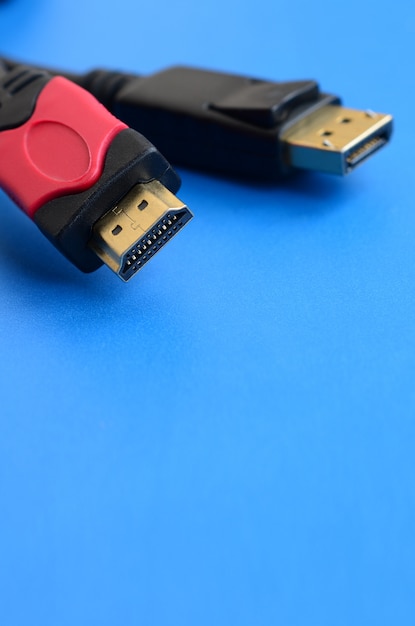 Audio video HDMI computer cable plug and 20-pin male DisplayPort gold plated connector for a flawless connection on a blue background