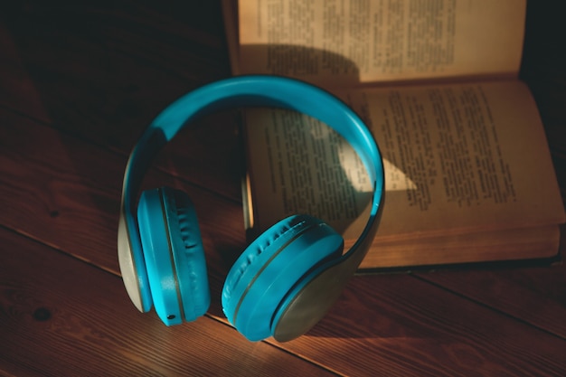 Audiobook concept. book and headphones on a wooden table