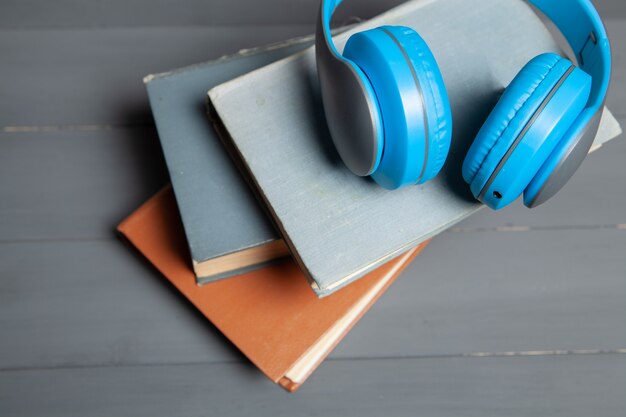 Audiobook concept. books and headphones on wooden the table